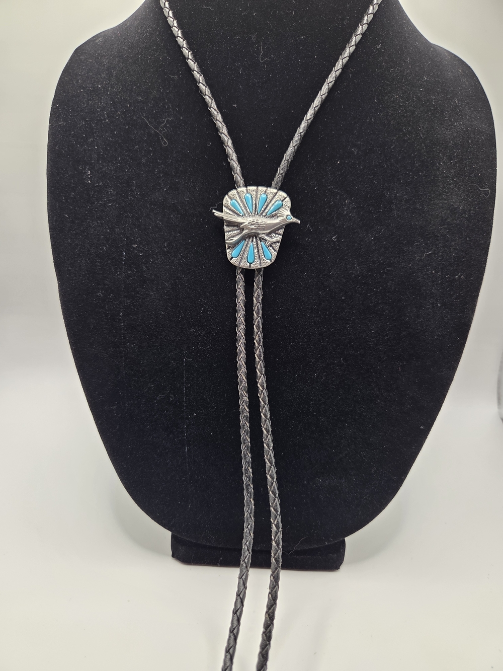 1650. Turquoise-Accented Silver Tone Road Runner Bolo Tie in Black Braided Cord
